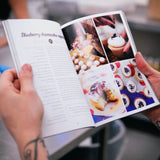 The Cake Book showing blueberry cheesecake cupcake recipe with step-by-step photos and tips by Crumbs & Doilies.